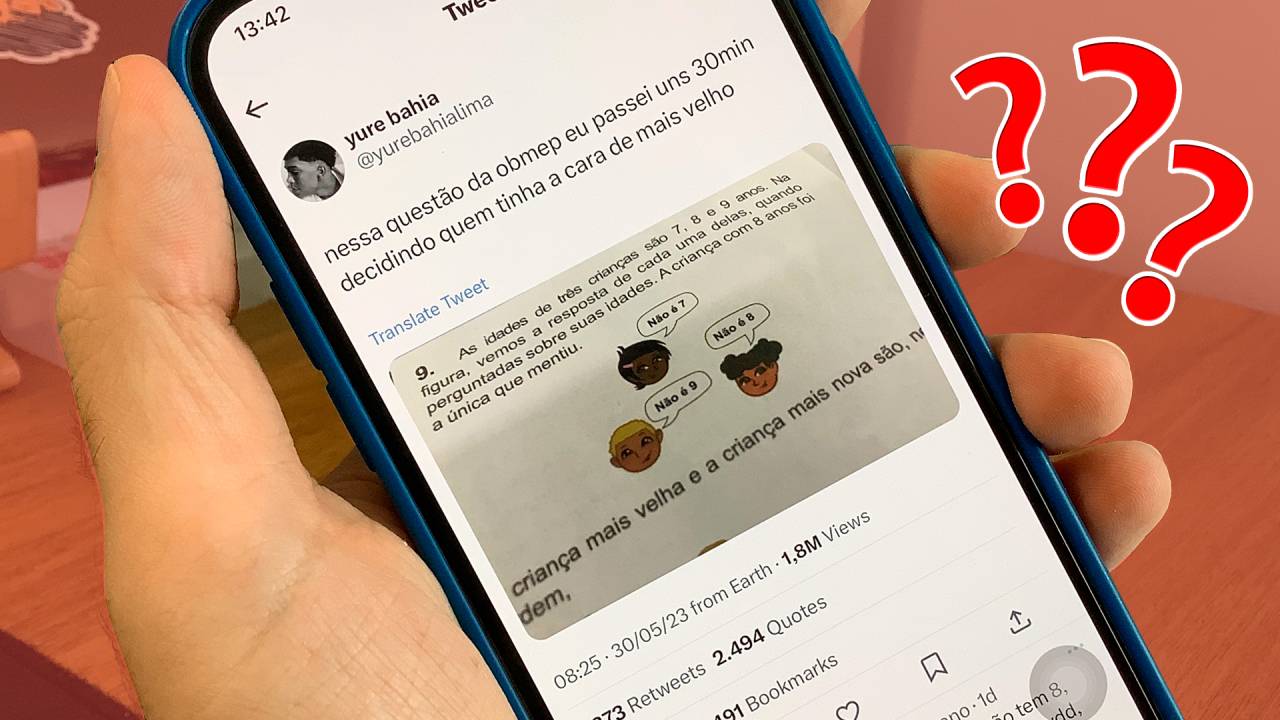 Mão segurando celular com tweet comentando a questão da OBMEP que viralizou nas redes